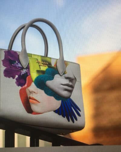 Stylish handbag featuring a vibrant face art illustration, perfect for fashion-forward accessories.