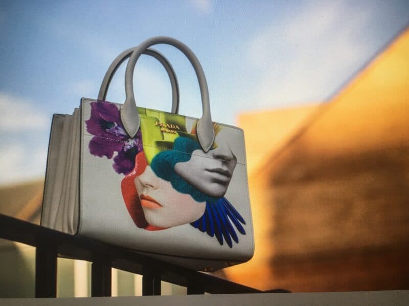Stylish handbag featuring a vibrant face art illustration, perfect for fashion-forward accessories.