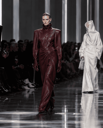 Elegant runway models showcase high-fashion leather and avant-garde designs at a modern fashion show.